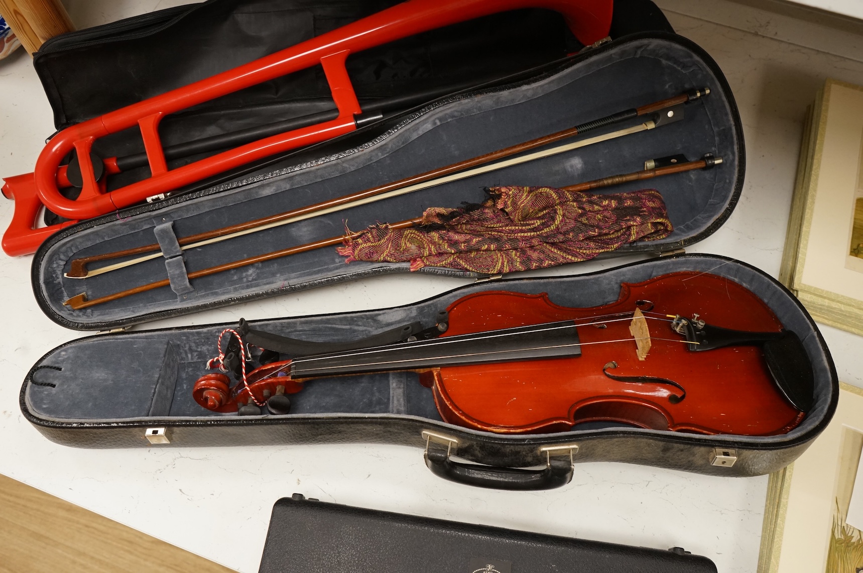 Three musical instruments to include a Buffet flute and violin with two bows